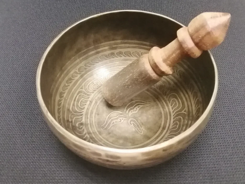 A singing bowl and its wooden striker